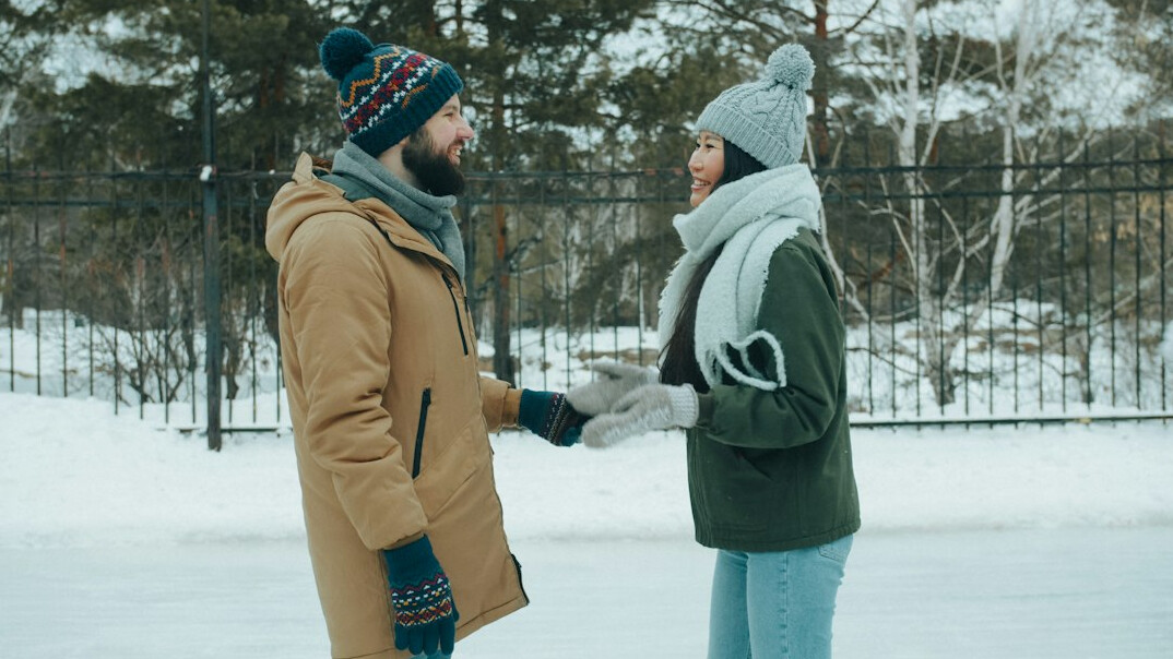 Two people having a warm, attentive conversation outdoors