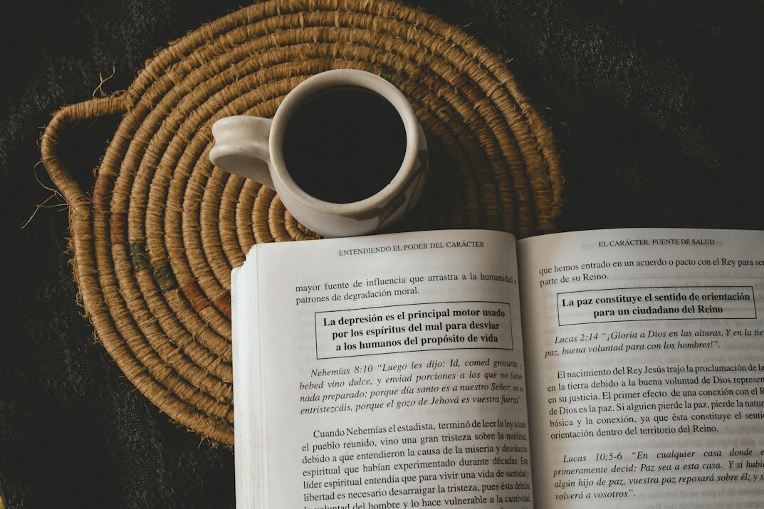 Open notebook with coffee cup on a wooden table