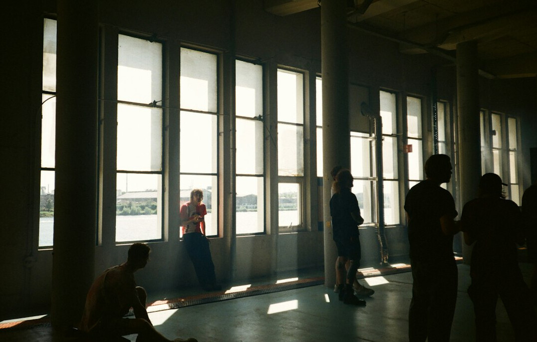 Small group of people talking in a bright room